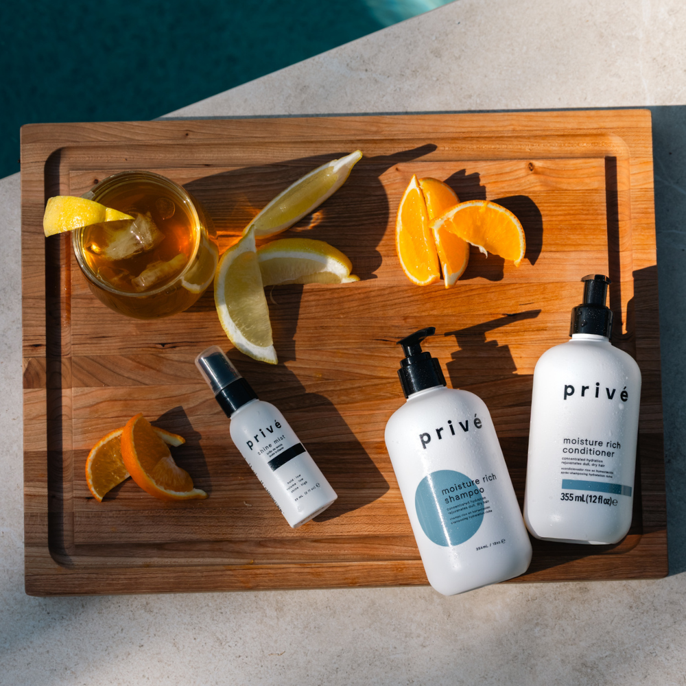 privé pro shine mist - product on wood with ingredients 